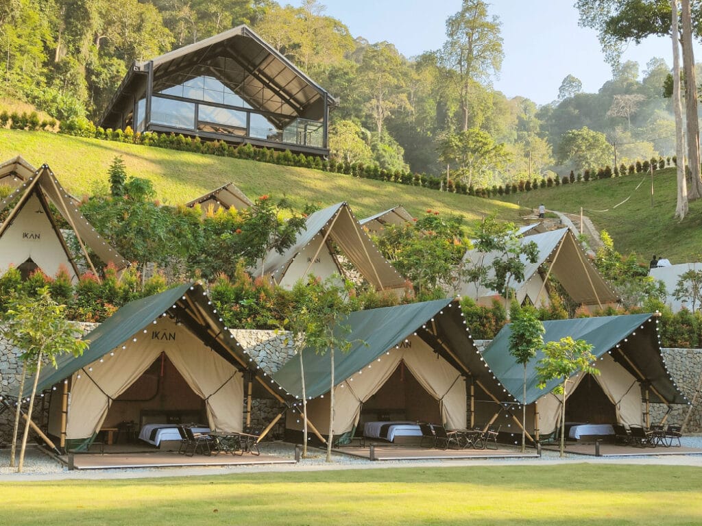 Glamping tents and sheltered event spaces at IKAN Glampsite designed for flexible outdoor events in changing weather.