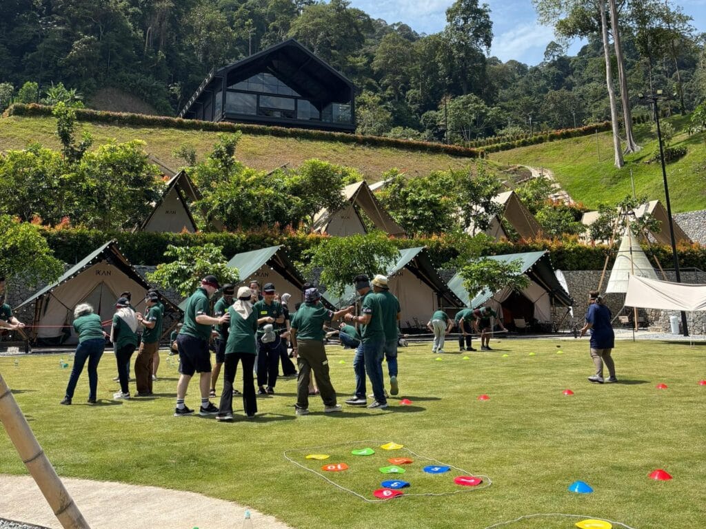 Evening outdoor dining and team building activities for corporate retreat at IKAN Glampsite glamping tents