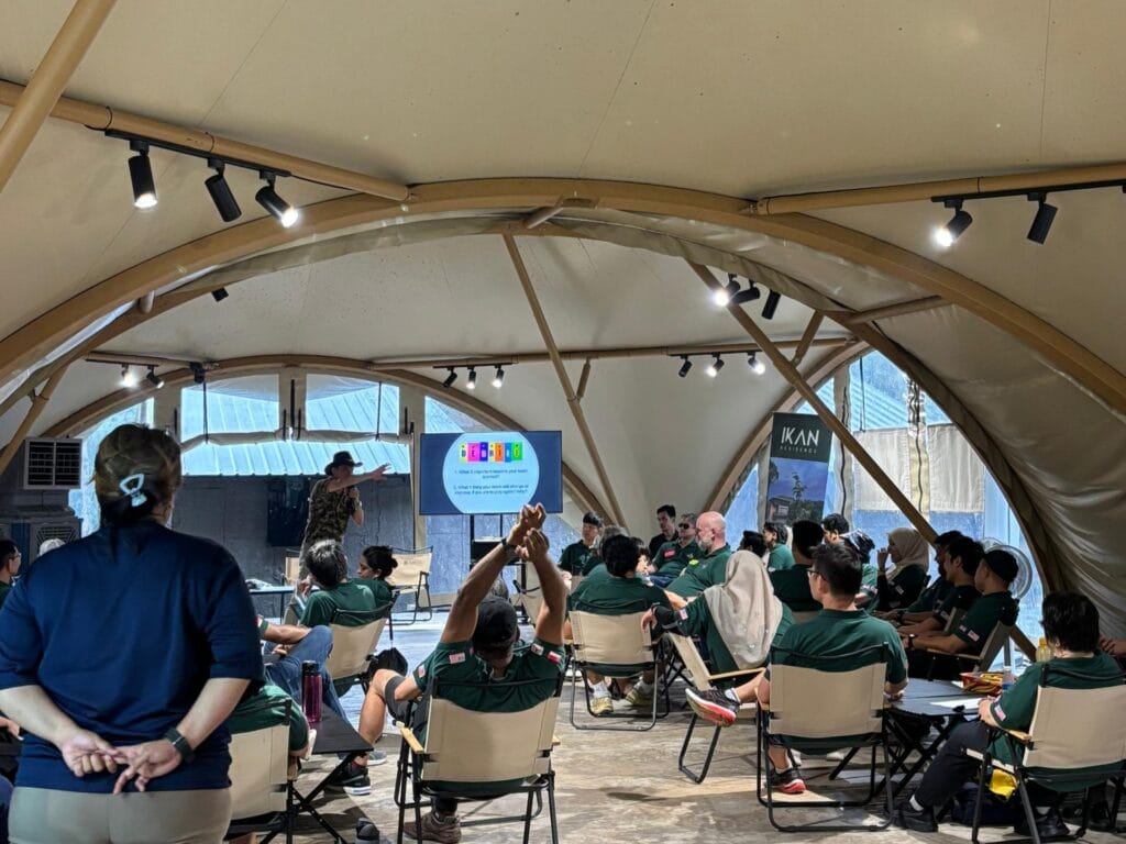 Corporate team building workshop held inside a luxury conference tent at IKAN Glampsite