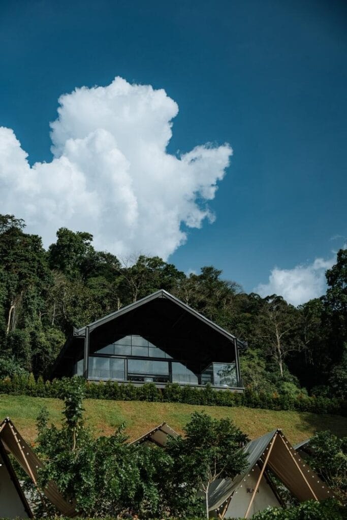 Scenic view of IKAN Glampsite’s event and conference hall surrounded by forest, offering a nature-based conference room venue near Kuala Lumpur.