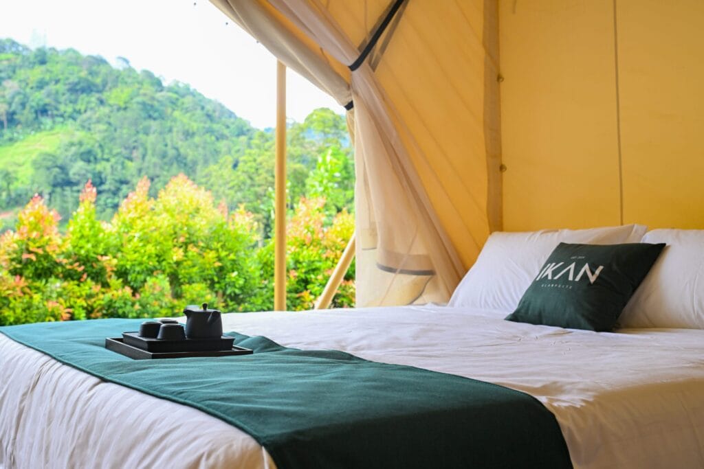 Glamping tent bedroom at IKAN Glampsite in Janda Baik with mountain view, cosy bed and nature surroundings