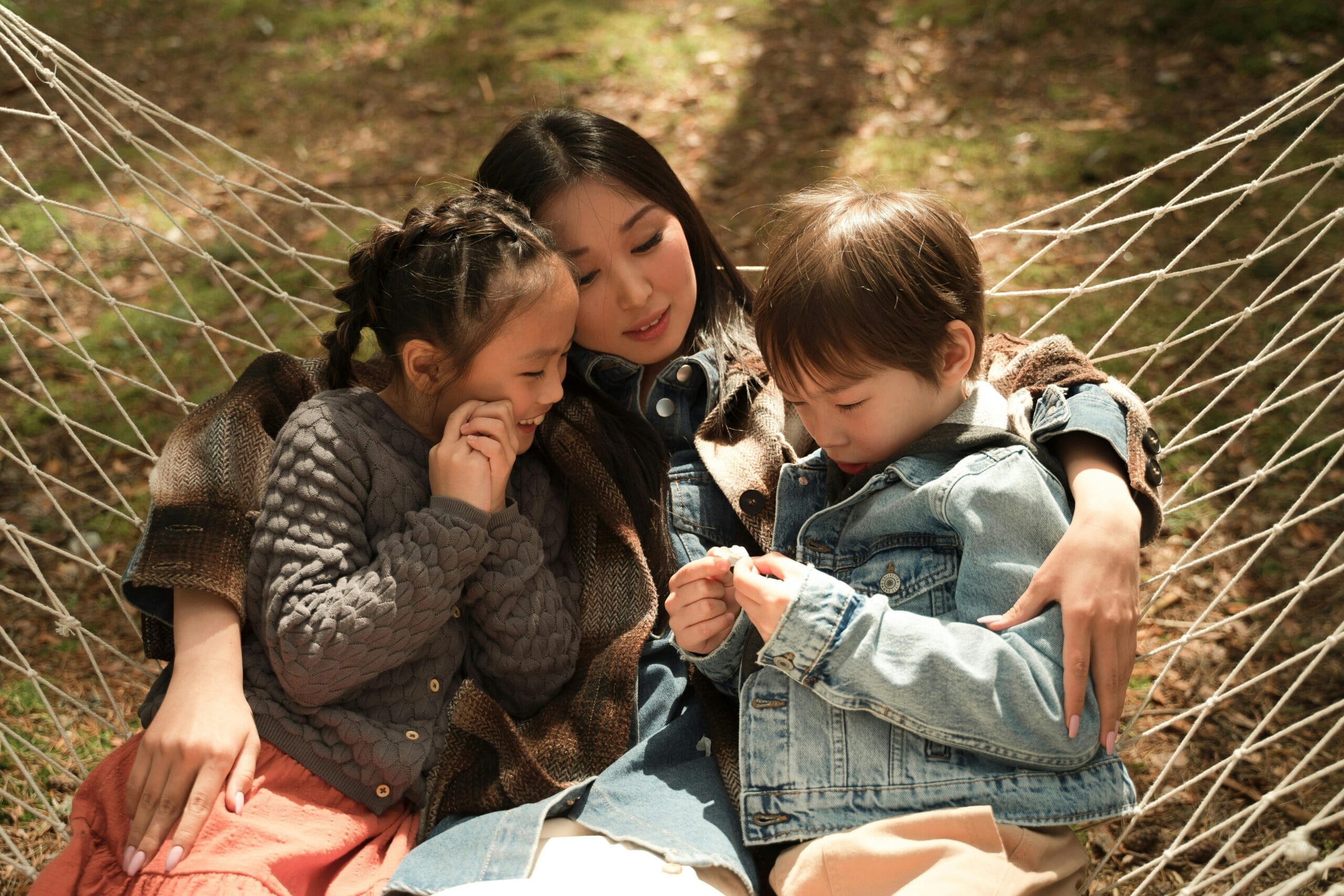 Family relaxing outdoors during a glamping trip, enjoying nature and quality time together
